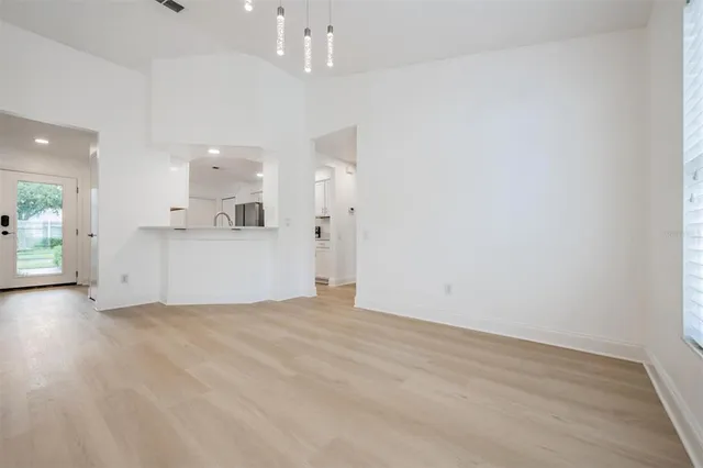 a view of a kitchen with a sink and a refrigerator