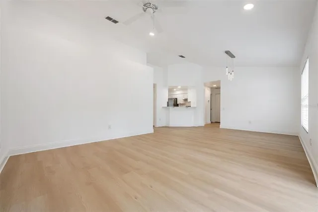 a view of empty room with wooden floor