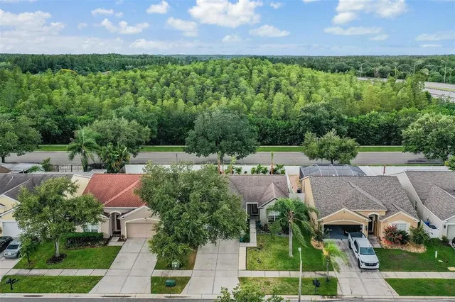 an aerial view of multiple houses with yard