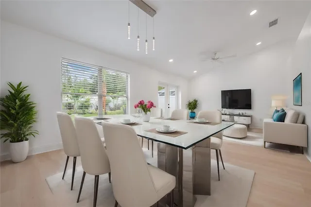 a view of a dining room with furniture window and wooden floor