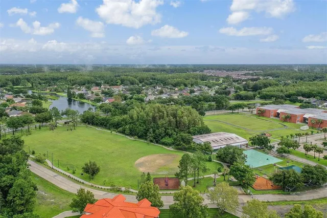 an aerial view of a house with a yard