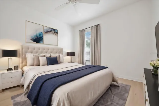 a bedroom with a bed and a painting on the wall