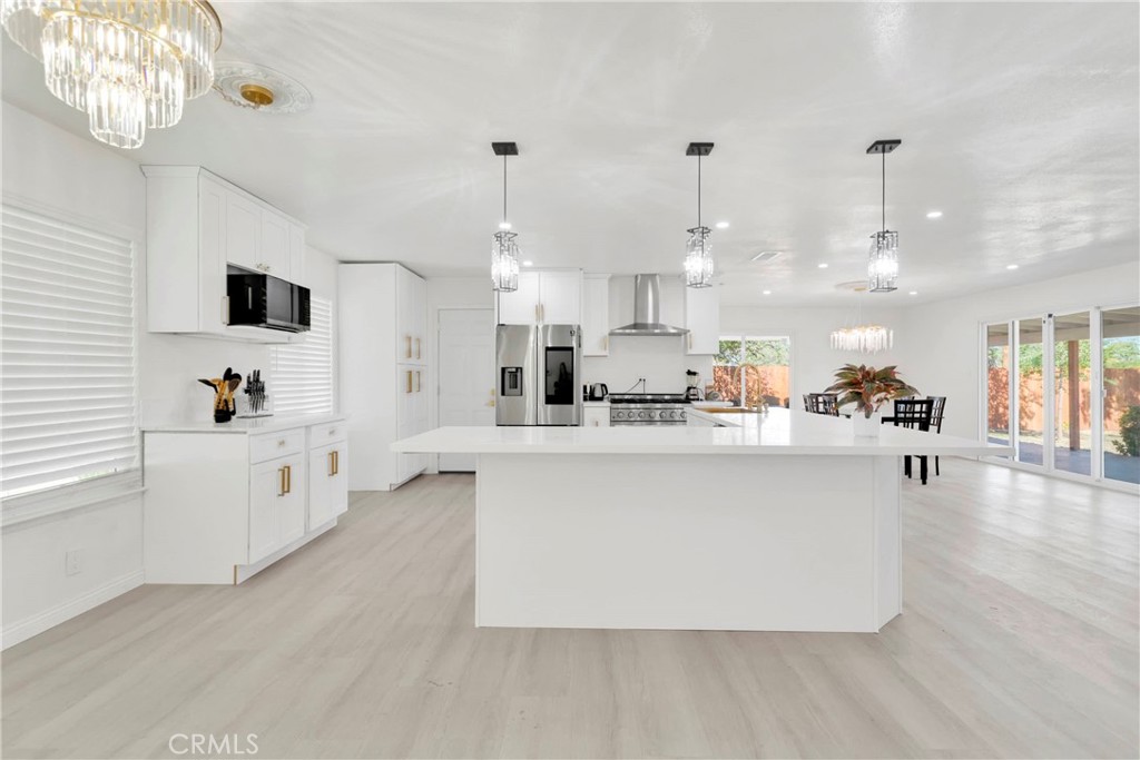 8263 3rd Avenue Hesperia, CA 92345 - Photo 11 of 56 a large white kitchen with lots of counter space and appliances