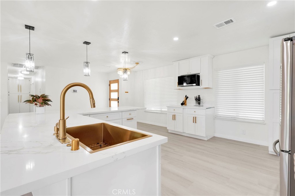 8263 3rd Avenue Hesperia, CA 92345 - Photo 15 of 56 a kitchen with a sink and a microwave