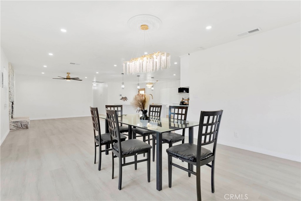 8263 3rd Avenue Hesperia, CA 92345 - Photo 16 of 56 a view of a dining room with furniture and chandelier