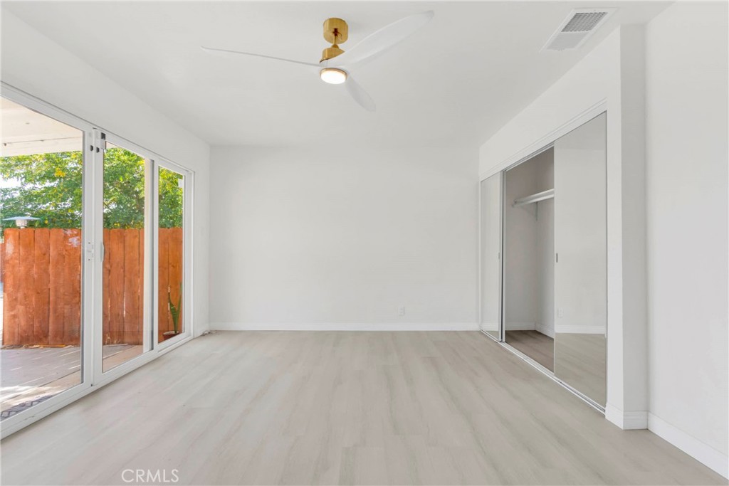 8263 3rd Avenue Hesperia, CA 92345 - Photo 19 of 56 wooden floor in an empty room with a window