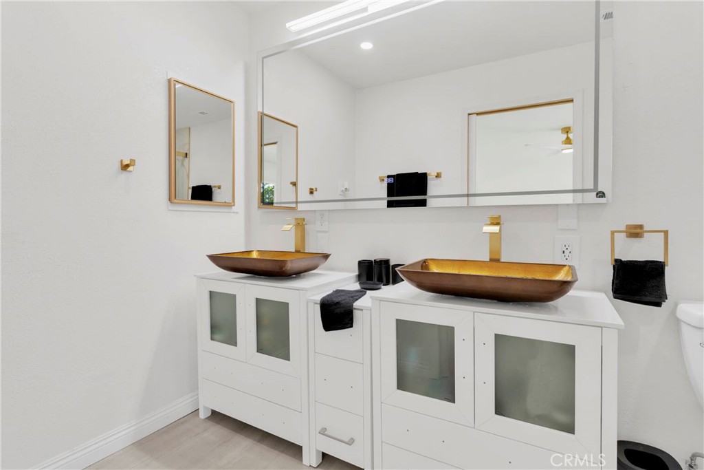 8263 3rd Avenue Hesperia, CA 92345 - Photo 21 of 56 a kitchen with stainless steel appliances kitchen island a stove a sink and a refrigerator