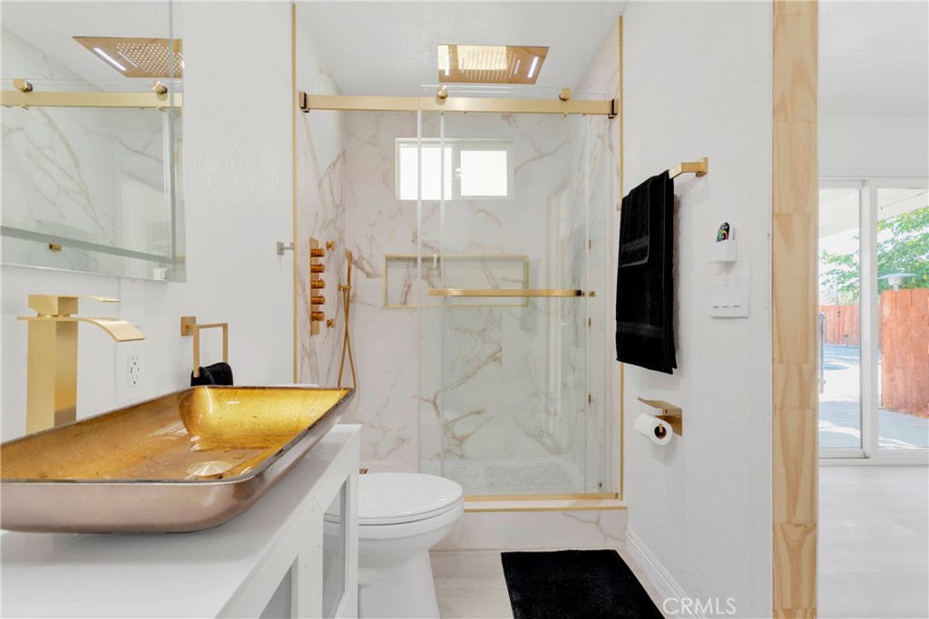 8263 3rd Avenue Hesperia, CA 92345 - Photo 22 of 56 a bathroom with a sink a toilet and shower