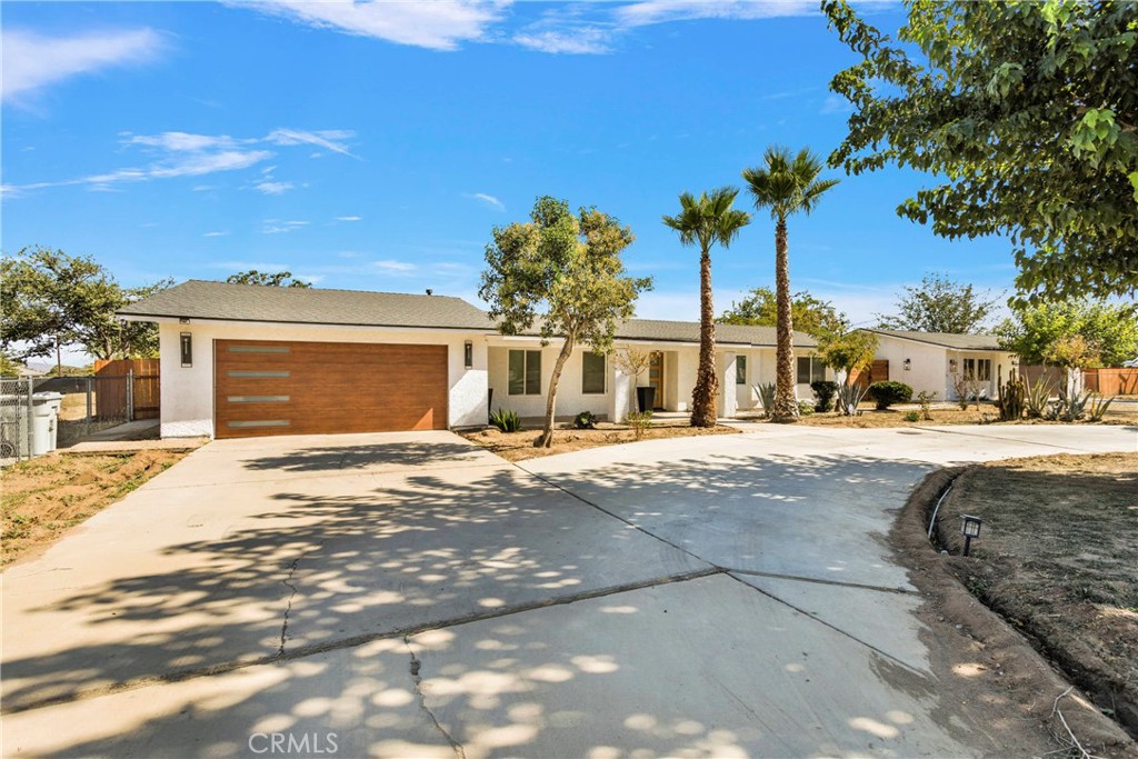 8263 3rd Avenue Hesperia, CA 92345 - Photo 3 of 56 a front view of a house with a yard