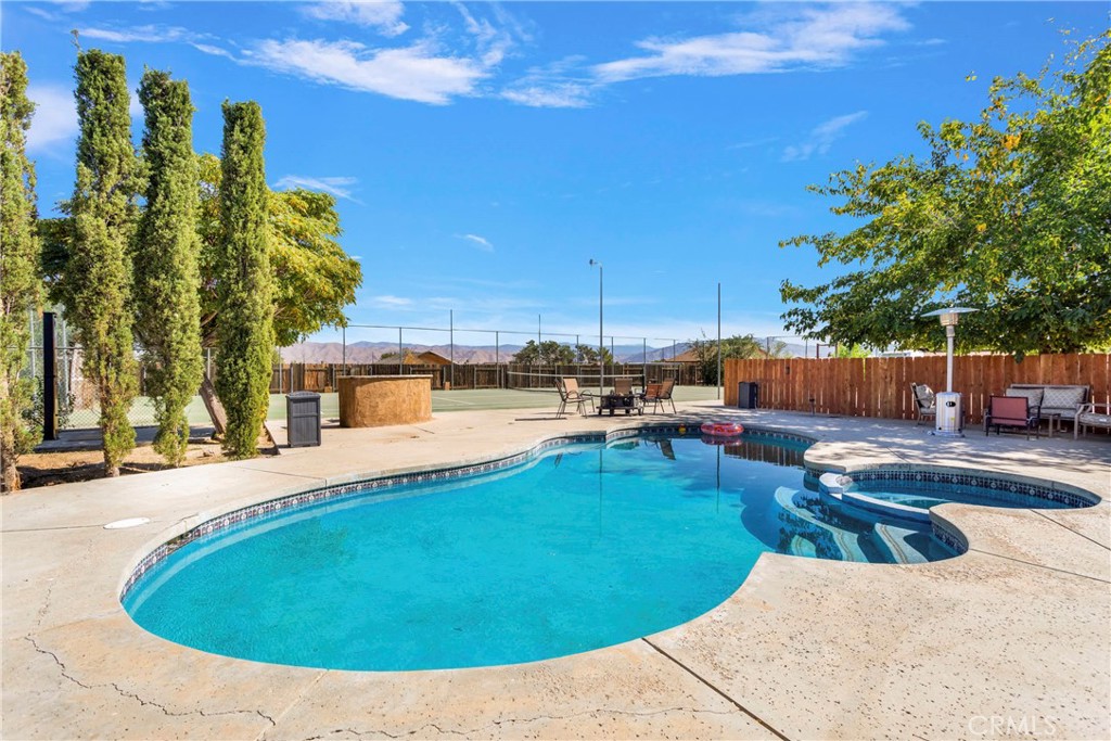 8263 3rd Avenue Hesperia, CA 92345 - Photo 41 of 56 a view of a swimming pool with a lounge chairs