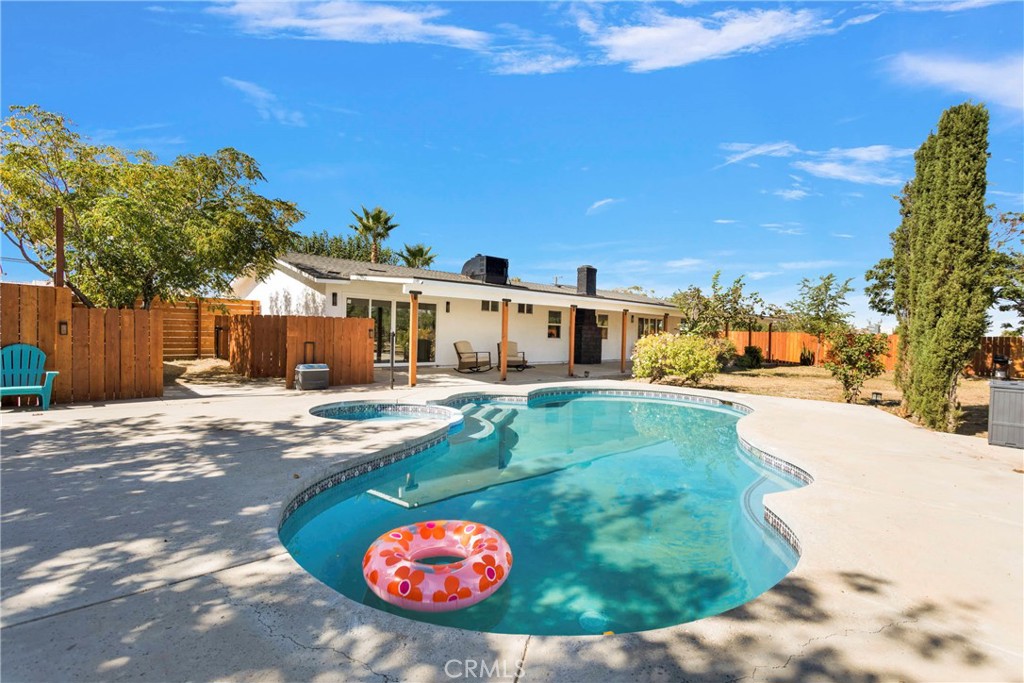 8263 3rd Avenue Hesperia, CA 92345 - Photo 42 of 56 a view of a swimming pool with a yard