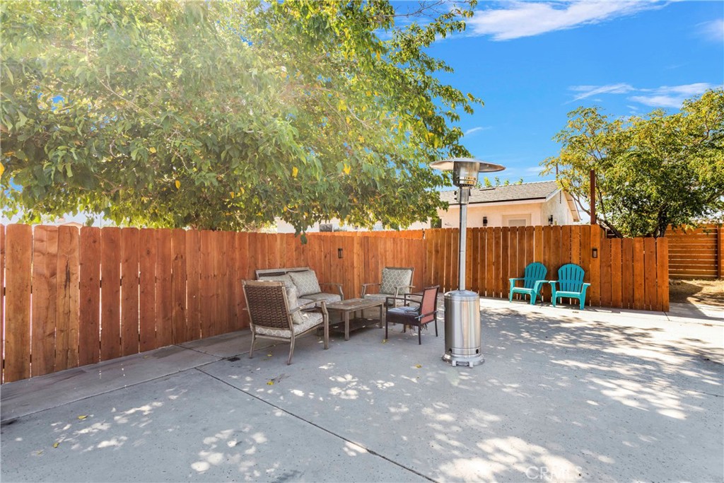 8263 3rd Avenue Hesperia, CA 92345 - Photo 43 of 56 a view of a chairs and tables in the back yard of the house
