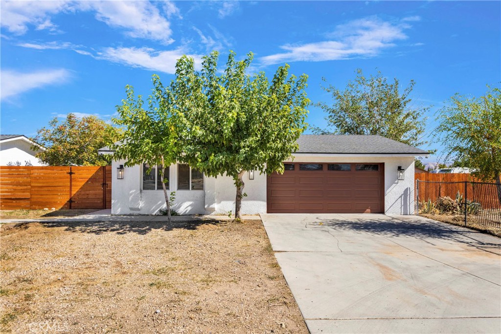 8263 3rd Avenue Hesperia, CA 92345 - Photo 6 of 56 a front view of a house with a yard
