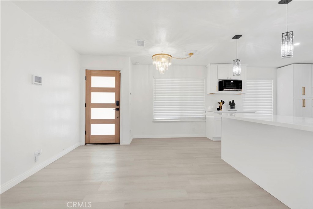 8263 3rd Avenue Hesperia, CA 92345 - Photo 8 of 56 a view of a kitchen with wooden cabinet and a fireplace