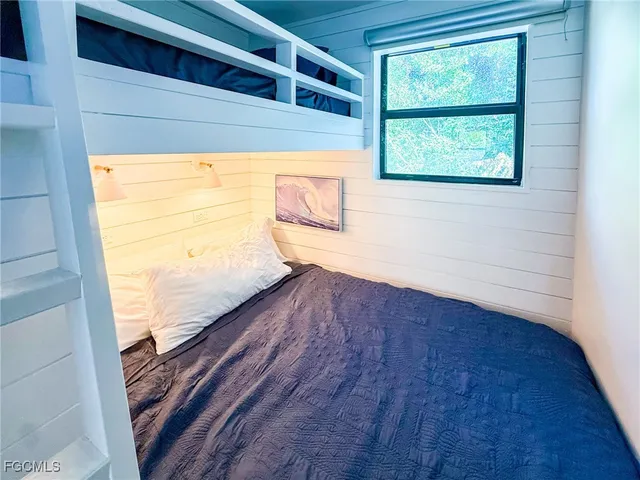 a living room with a bed and a table