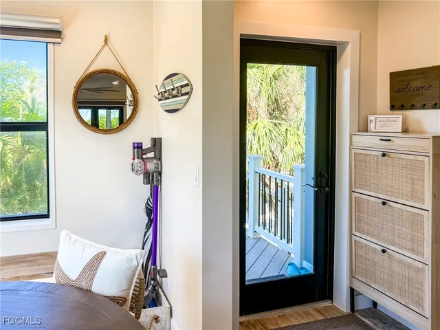 a living room with a large window and a wooden floor