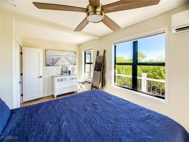 a bedroom with a bed closet and a flat tv screen