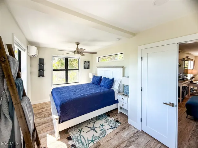 a living room with furniture a wooden floor and a sink