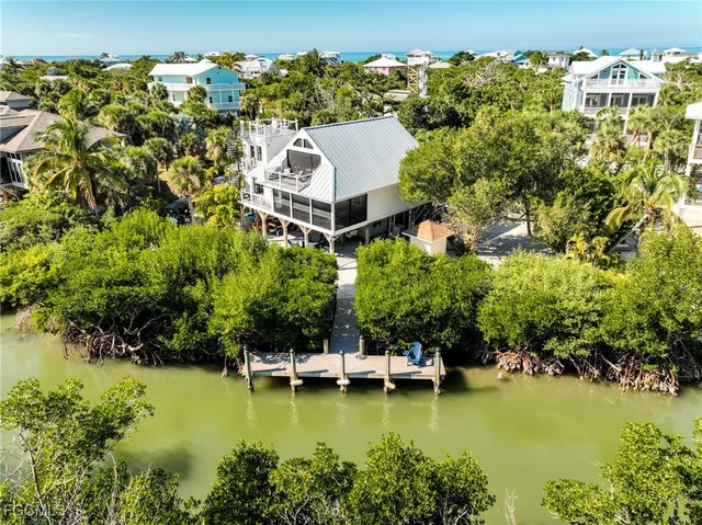 an aerial view of a house with a garden lake view