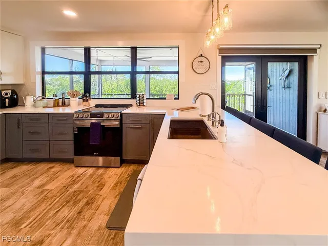 a kitchen with stainless steel appliances granite countertop a refrigerator and a stove
