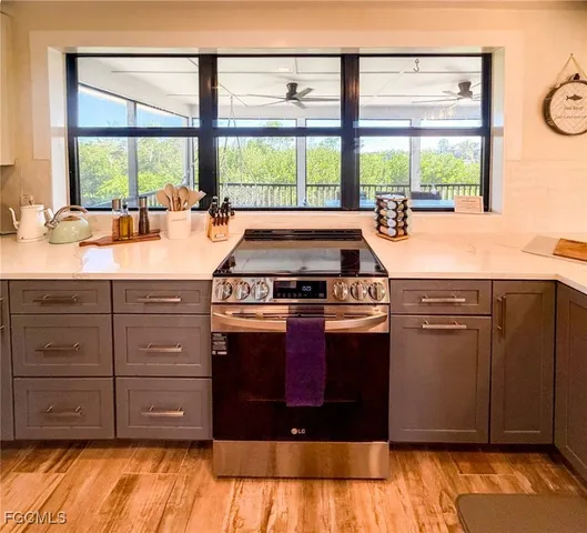 a kitchen with stainless steel appliances granite countertop a sink and stove