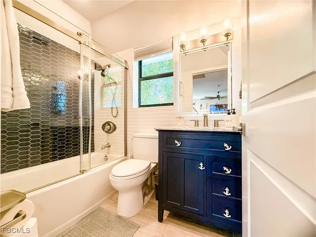 a spacious bedroom with a bed and a dresser