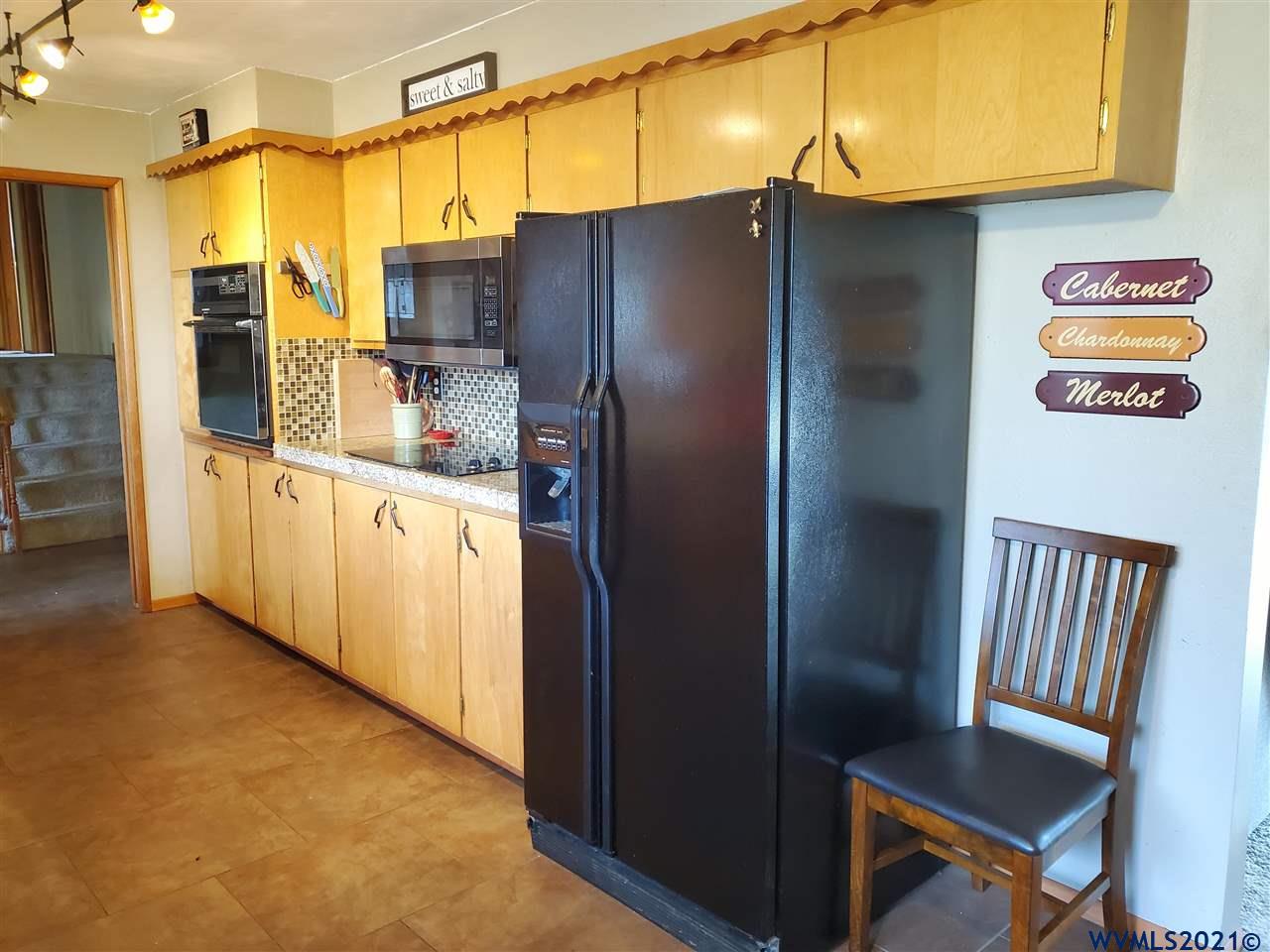 231 Northwest Reed Lane Dallas, OR 97338 - Photo 6 of 41 a kitchen with stainless steel appliances granite countertop a refrigerator and a stove