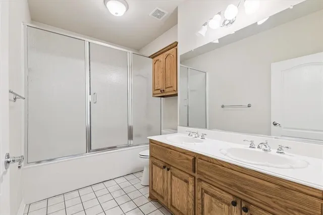 a spacious bathroom with a double vanity sink mirror and shower
