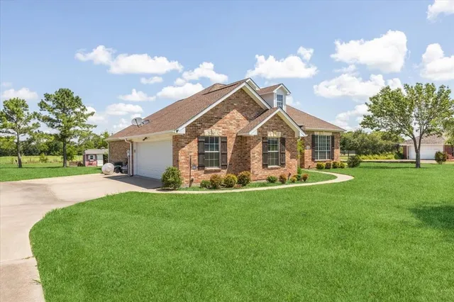 a view of a house with a yard and sitting area