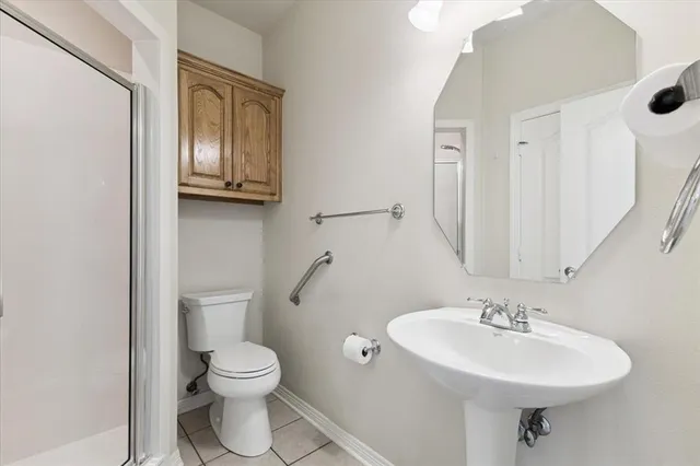 a bathroom with a toilet a sink and mirror