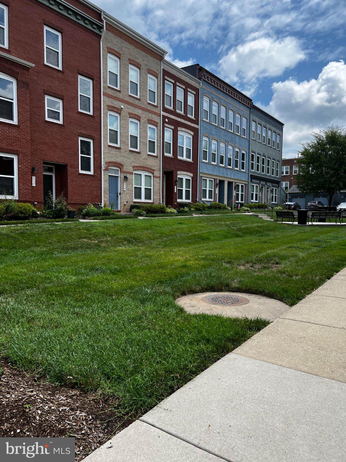 8925 Quarry Road Manassas, VA 20110 - Photo 2 of 9 Charming row homes under blue skies.