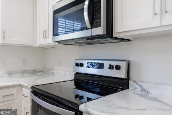 a kitchen with stainless steel appliances a stove and a microwave