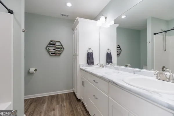 a bathroom with a double vanity sink and a mirror