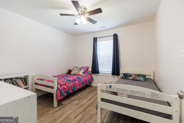 a bedroom with a bed and a book shelf