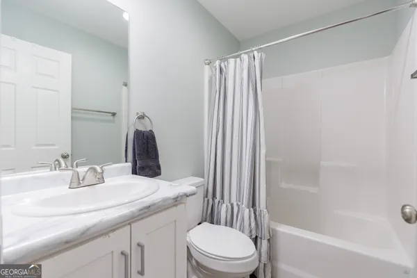 a bathroom with a bath tub with a shower