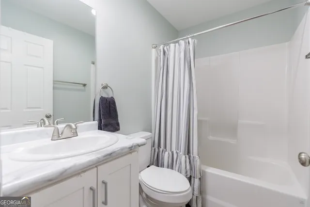 a bathroom with a bath tub with a shower