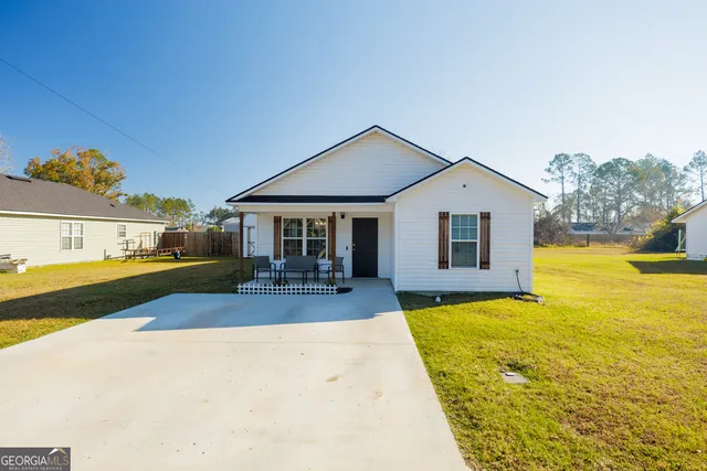 a front view of a house with swimming pool having outdoor seating