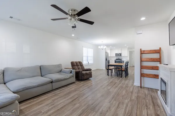 a living room with furniture and a wooden floor