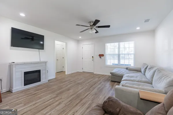 a living room with furniture a fireplace and a flat screen tv