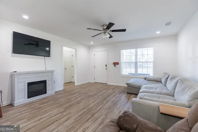 a living room with furniture a fireplace and a flat screen tv