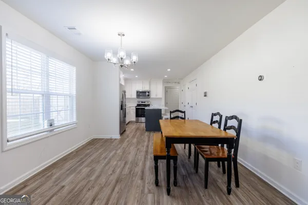 a view of a dining room with furniture and window