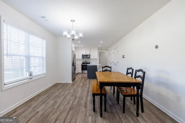 a view of a dining room with furniture and window