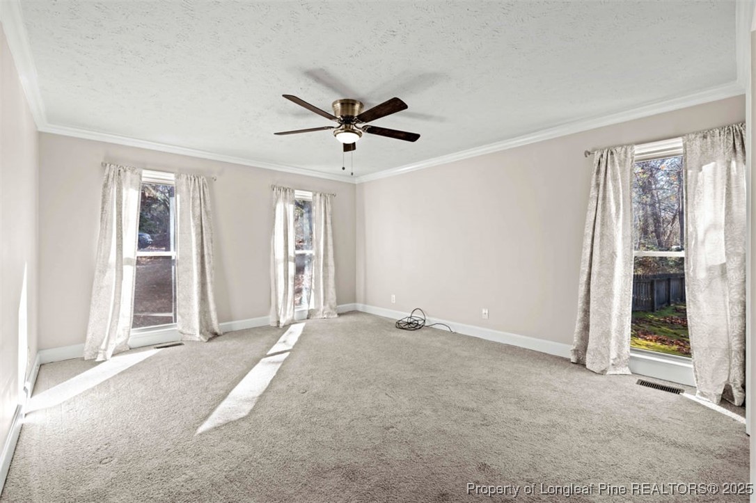 6922 South Staff Road Fayetteville, NC 28306 - Photo 15 of 45 a view of a livingroom with a ceiling fan and window