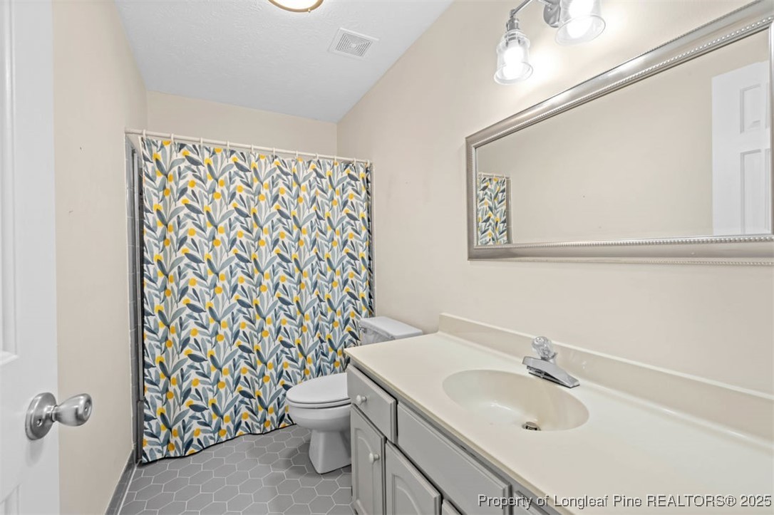 6922 South Staff Road Fayetteville, NC 28306 - Photo 26 of 45 a bathroom with a sink toilet and shower