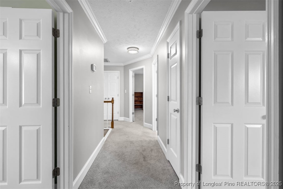 6922 South Staff Road Fayetteville, NC 28306 - Photo 30 of 45 a view of a hallway with wooden shelves