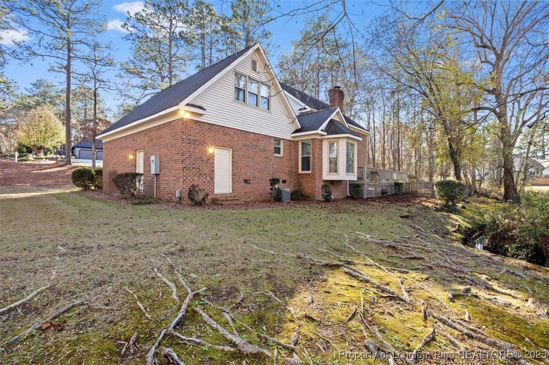 6922 South Staff Road Fayetteville, NC 28306 - Photo 37 of 45 a front view of a house with garden