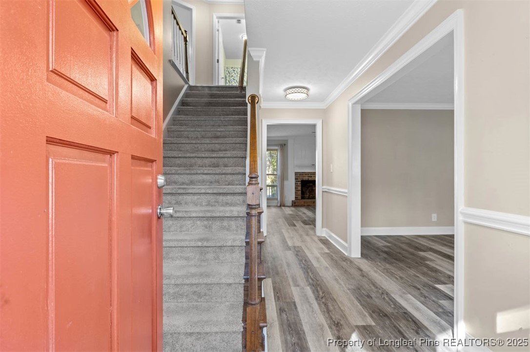 6922 South Staff Road Fayetteville, NC 28306 - Photo 4 of 45 a view of a hallway with wooden floor and staircase