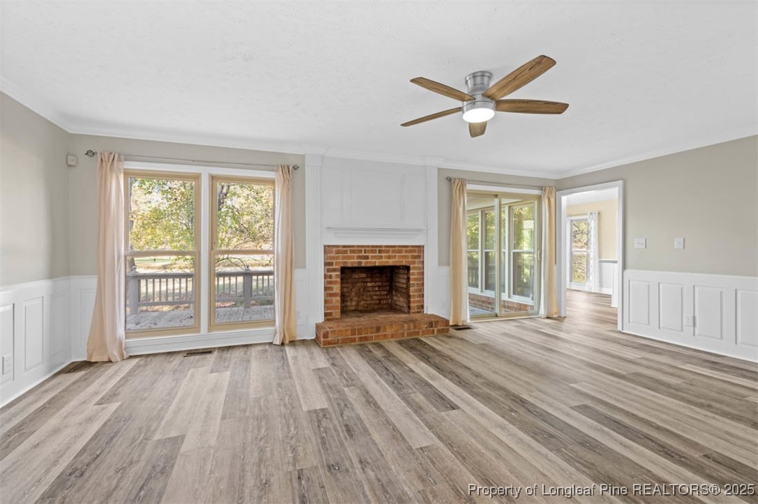 6922 South Staff Road Fayetteville, NC 28306 - Photo 6 of 45 a view of empty room with wooden floor and fireplace