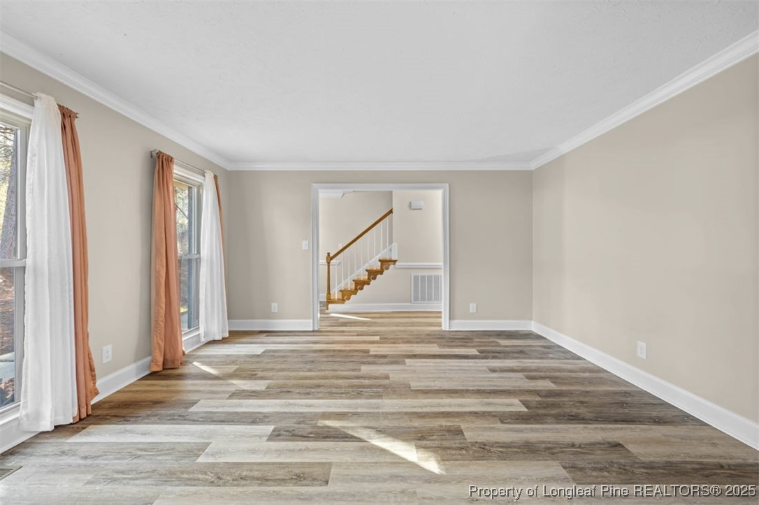 6922 South Staff Road Fayetteville, NC 28306 - Photo 8 of 45 a view of empty room with wooden floor and fan