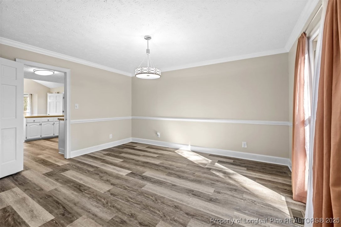 6922 South Staff Road Fayetteville, NC 28306 - Photo 10 of 45 a view of empty room with wooden floor